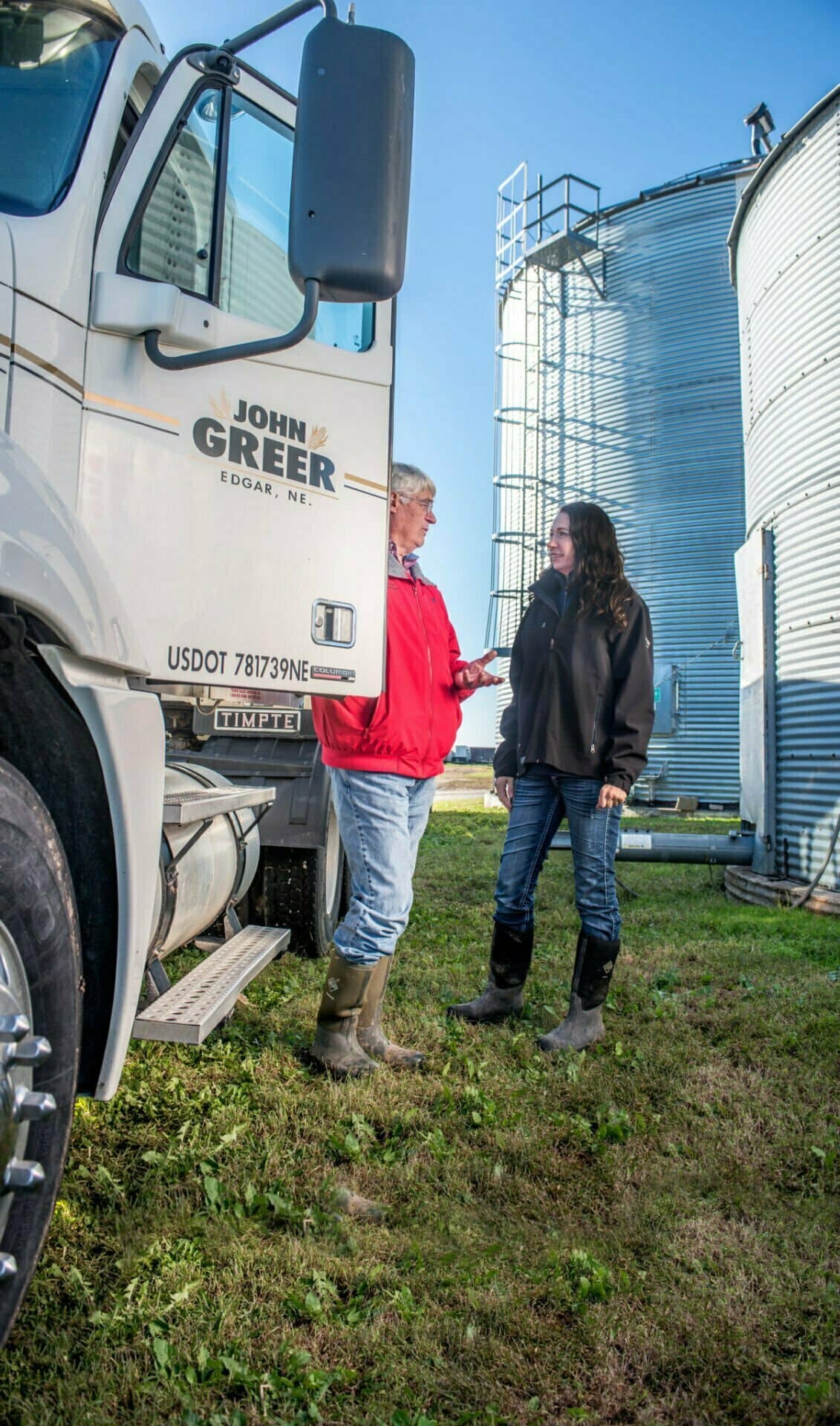 two people talking at corn farm