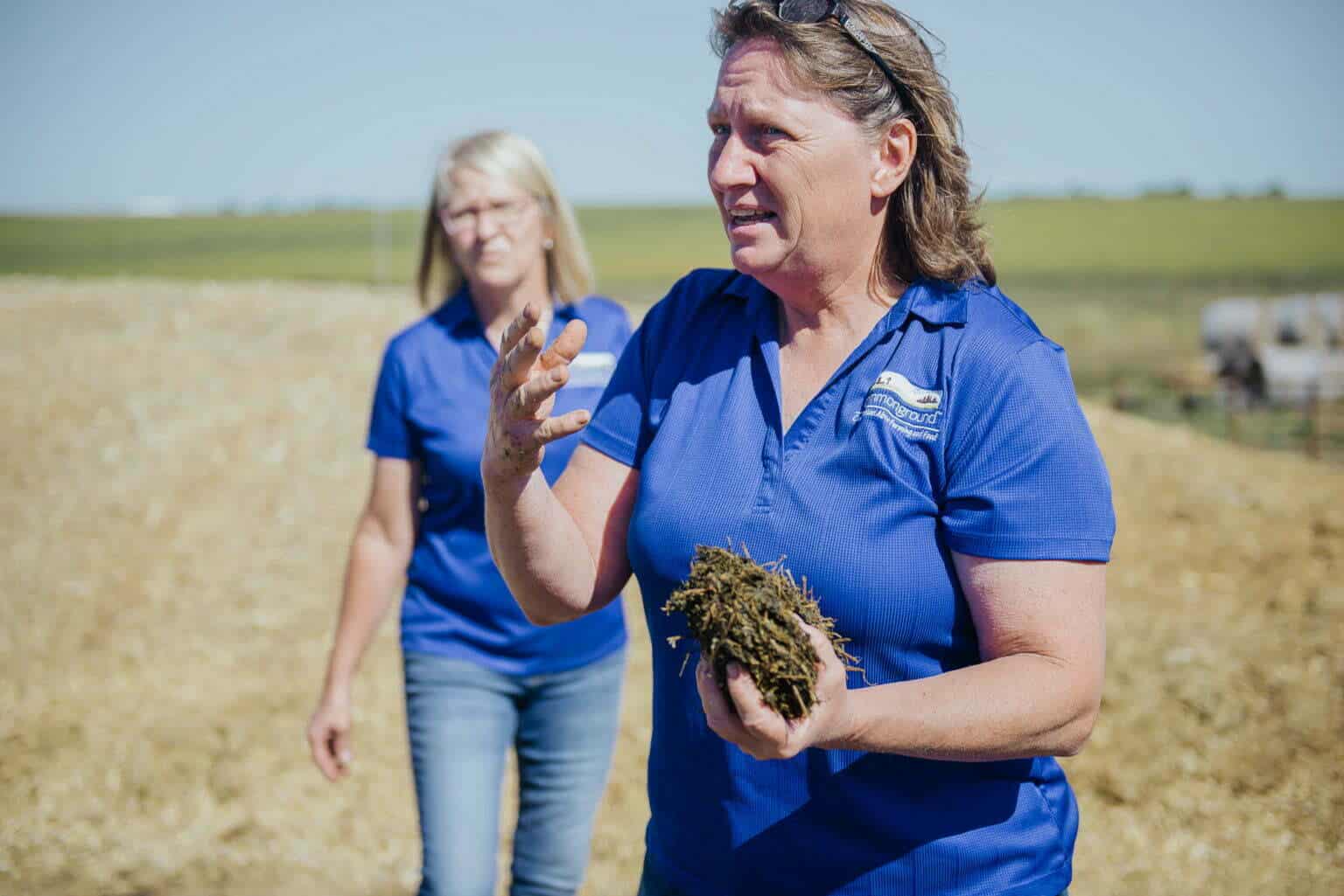 women holding chunk of soil