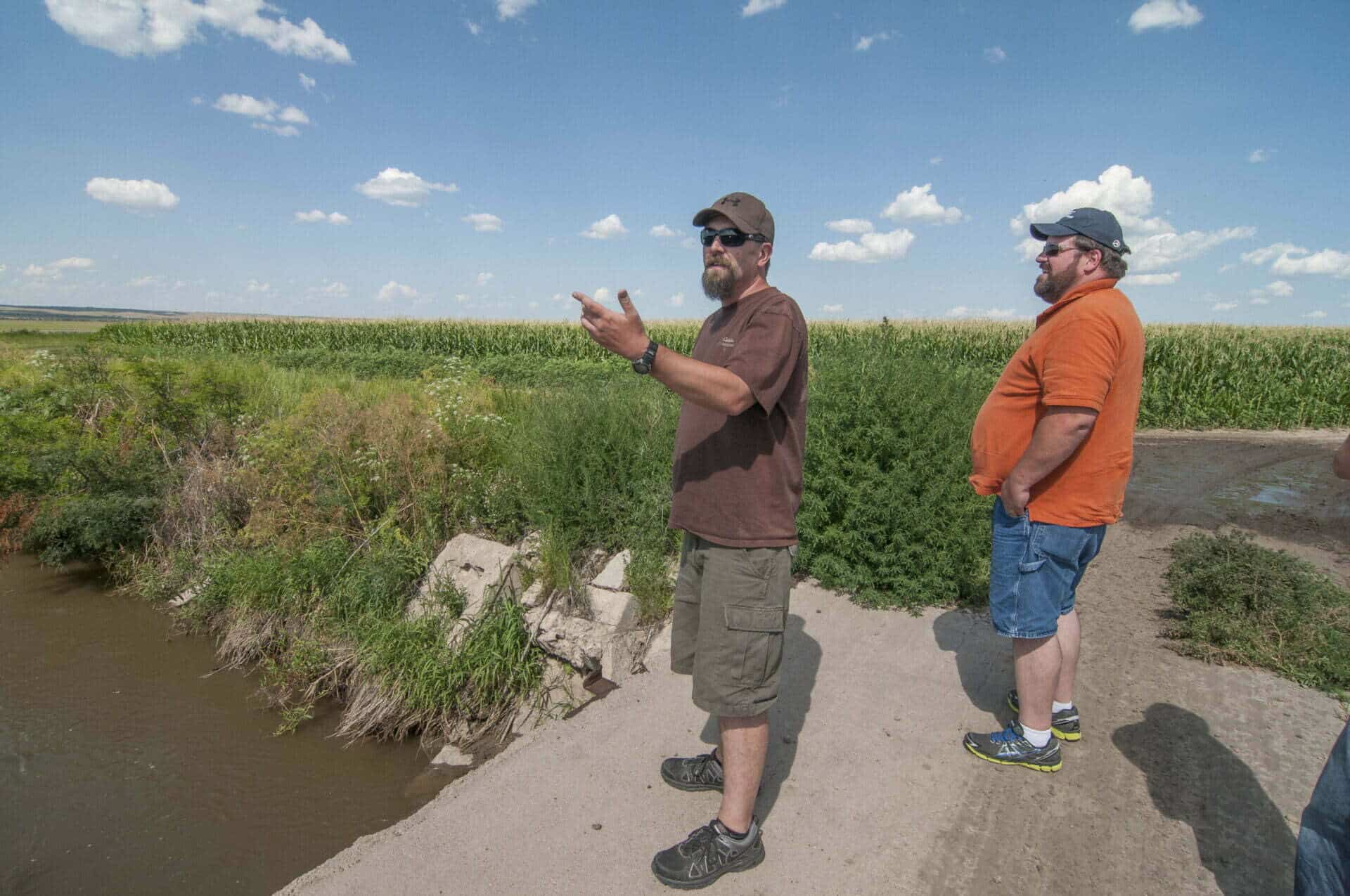 Jacob Fritton and John Heaston, both of TNC, look at an irrigation canal near Ogallala, Nebraska.