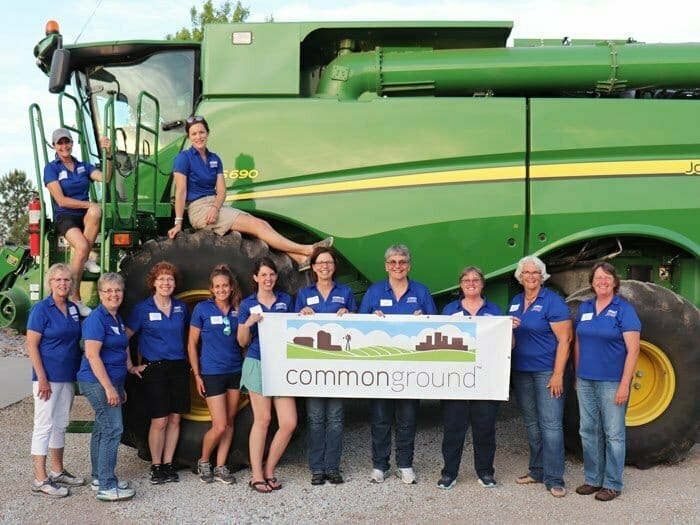 Nebraska Corn's Common Ground group in front of a combine