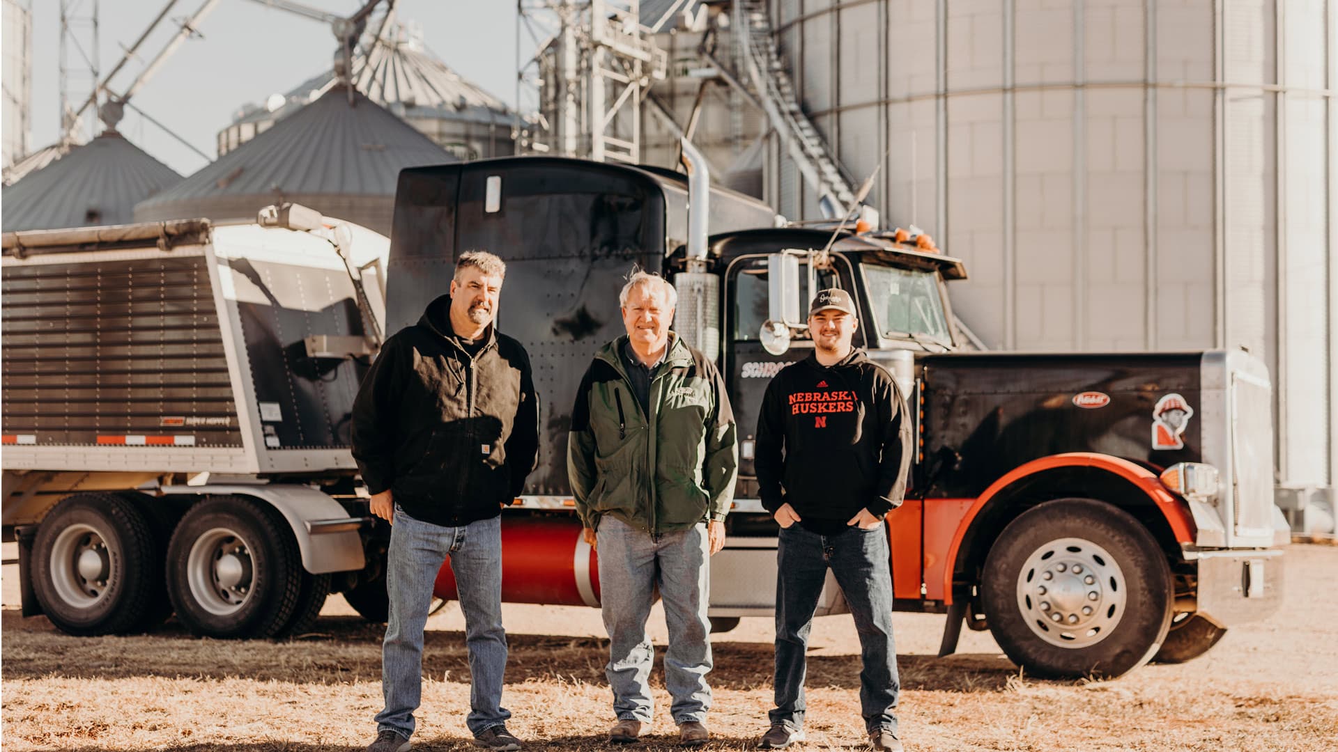 Farmers standing in front of semi
