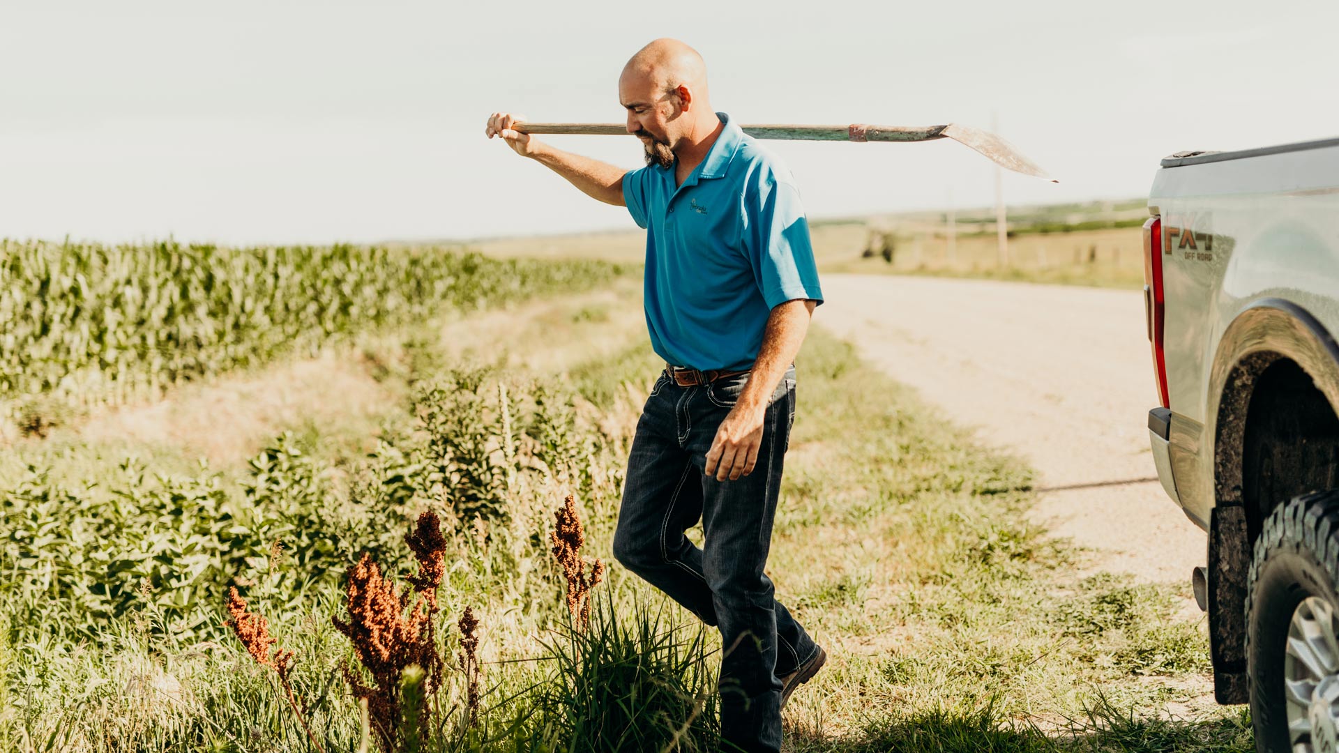 Man with a shovel at a corn field