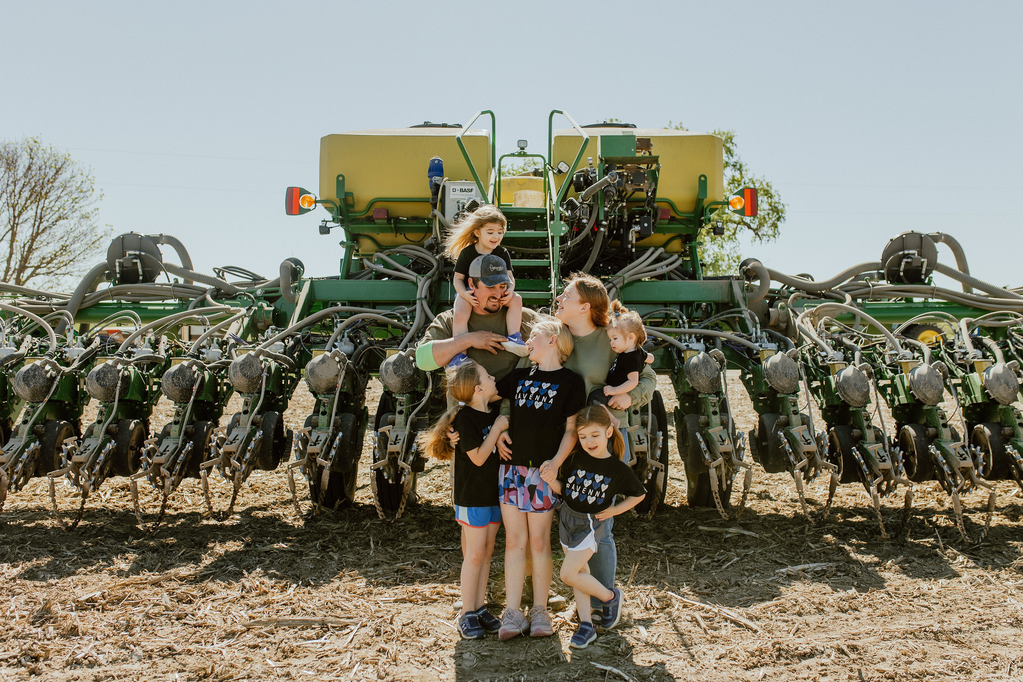 Family in front of combine