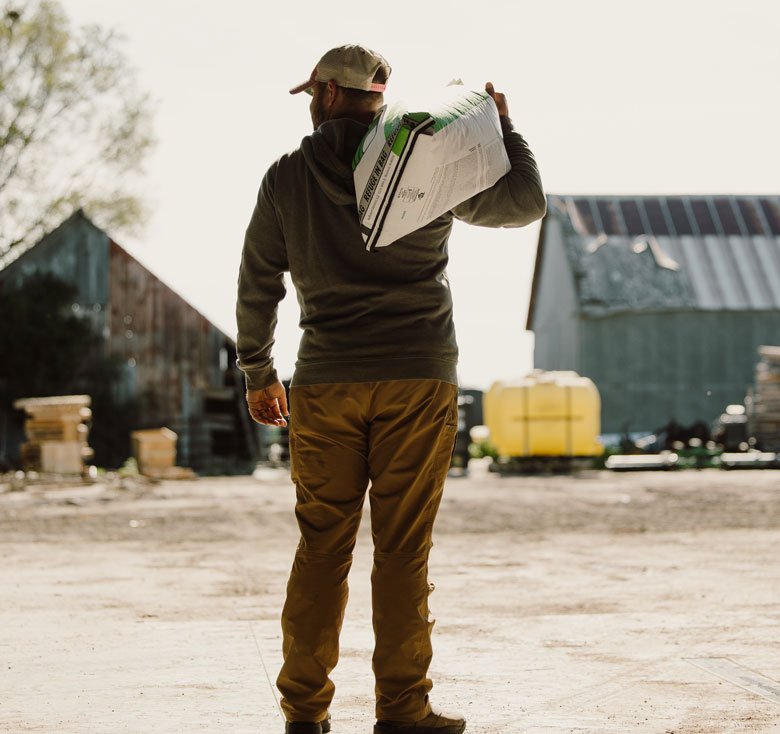 Farmer with bag feed on his shoulder