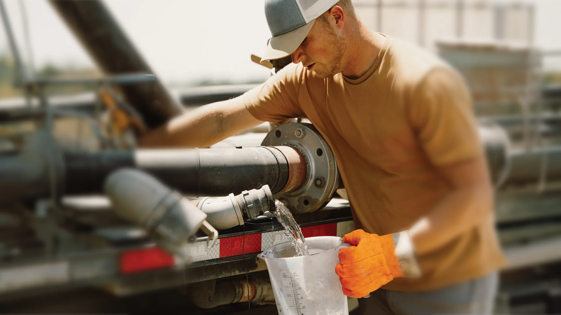 man diverting water from an irrigation pipeline